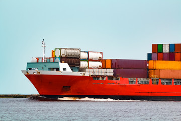 Red container ship underway