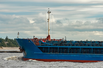 Blue cargo ship underway