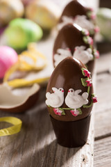 Decorated Chocolate easter egg on wooden table