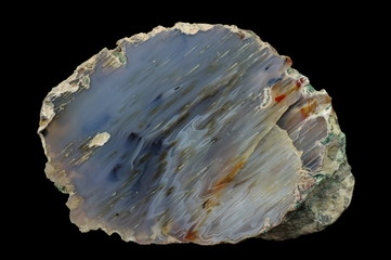 A cross-section of agate. Micro-stalactite agate (in reverse position). Multicolored silica bands...