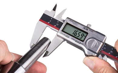 Accuracy measurement of stainless steel part by digital calipers. Detail of a worker's hand holding the digital measuring tool and metal morse taper. Isolated on white background.