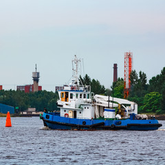 Fototapeta premium Blue tug ship underway