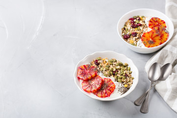 Healthy morning breakfast with granola yogurt blood oranges