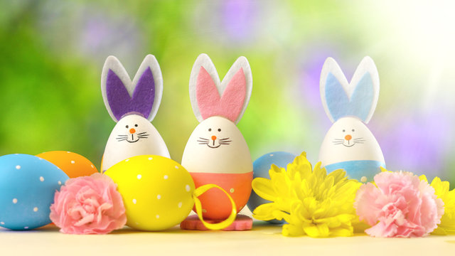 Cute Easter bunny ornaments and Easter Eggs on white table against garden background with lens flare.