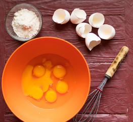 Ingredients for baking - broken eggs, flour.