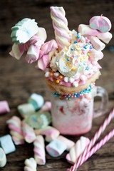Extreme milkshake or freak shake . Copyspace,  strawberry freakshake with sweets 