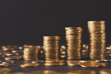 Increasing columns of gold coins on table