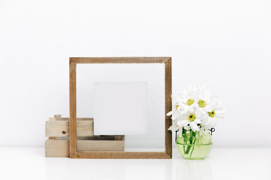 Wooden frame mock up with spring flowers in vase.  Nordic Scandinavian style home interior