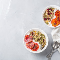 Healthy morning breakfast with granola yogurt blood oranges