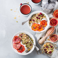 Healthy morning breakfast with granola yogurt blood oranges