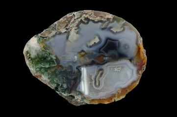 A cross-section of agate. Multicolored silica bands colored with metal oxides are visible. Origin:...