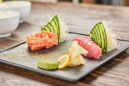 Delicious salmon and tuna sashimi set. Sliced salmon and tuna on traditional japanese plate. Restaurant of japanese food.