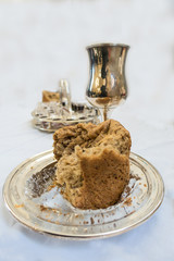 A bread and silver chalice holding wine form part of the act of Holy Communion in which Chistinas remember the Last Supper that Jesus had with his disciples.