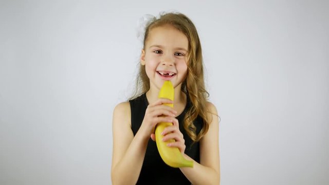 Funny girl singing with a banana.