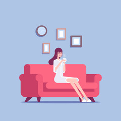 A young woman in a bathrobe sits on a sofa with a cup of coffee or tea in her hands. Smiling girl resting on couch after shower vector flat illustration