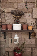 View of decorative objects and flower pots on stone wall in Cunda (Alibey) island.