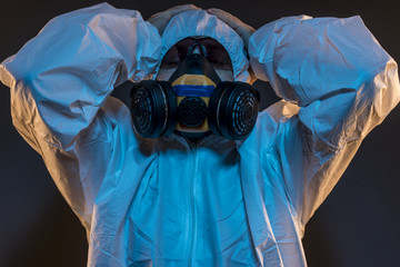 Quarantine, virus infection concept. Man in protective suit and antigas mask with glasses. Ebola,...