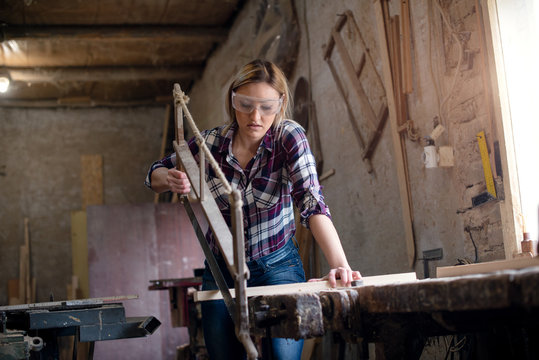 Woman is cutting wood manual