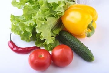 Assorted vegetables, fresh bell pepper, tomato, chilli pepper, cucumber and lettuce isolated on white background. Selective focus.