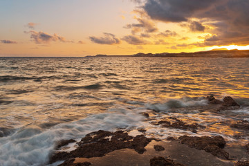 Fototapeta na wymiar sea sunset at stones beach