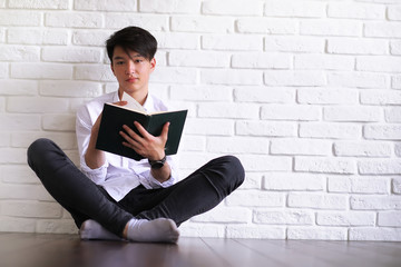 Asian young man student with books