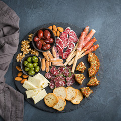 Assortment of spanish tapas or italian antipasti with meat