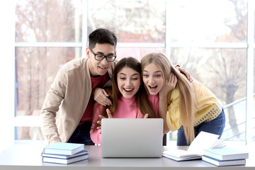 Excited students finding out their excellent grades for examination indoors