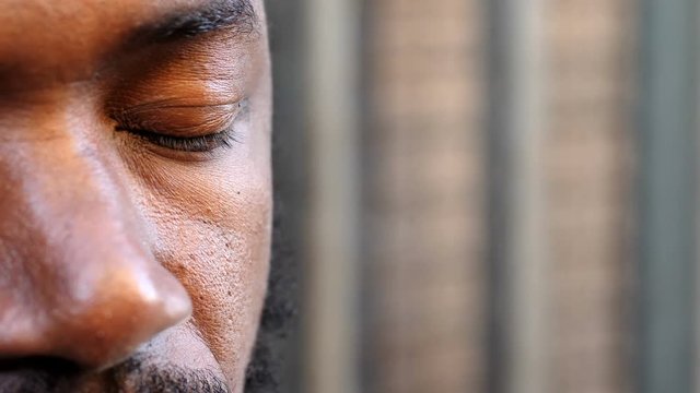 African black man opens his eyes slowly - hope, future, optimism- close up