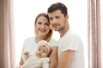 Young parents with baby at home