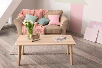 Elegant living room interior with table and comfortable sofa