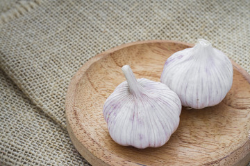 garlic bulbs on wood, selective focus