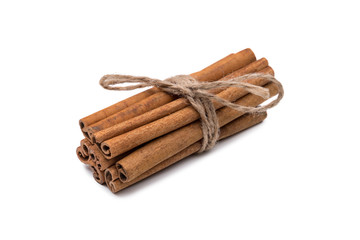 Cinnamon sticks spice tied with a rope, isolated on white background. View slightly from above.