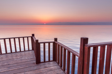 Fototapeta na wymiar Picturesque Viewpoint on sunset seascape over Mediterranean sea in European country from wooden terrace.