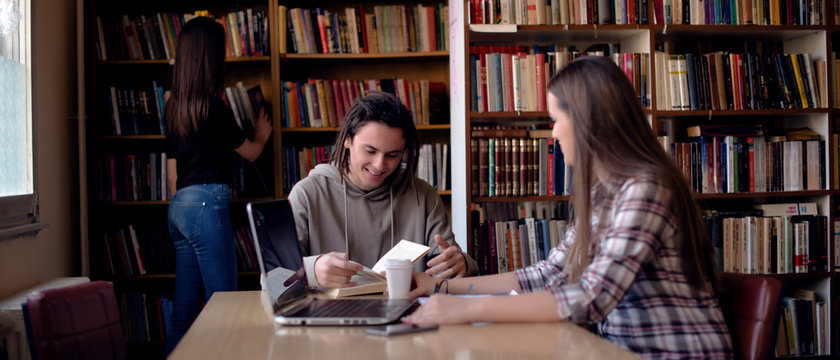 Cropped image of students learning in library