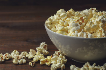 Popcorn in plate on table, copy space