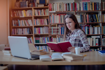 Confident female student learning in library