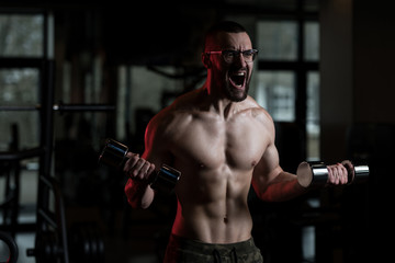 Fototapeta na wymiar Geek Man With Dumbbell Exercising Biceps
