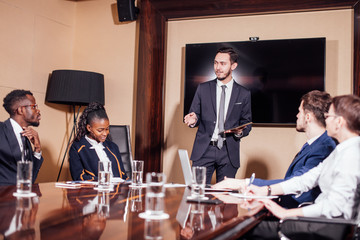 Businessman presenting to colleagues at a meeting