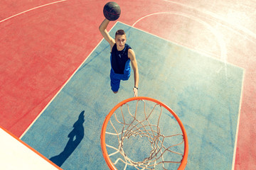 High angle view of basketball player dunking basketball in hoop