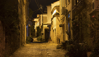 Fototapeta na wymiar Night view of historical, old street in old town of Cunda (Alibe
