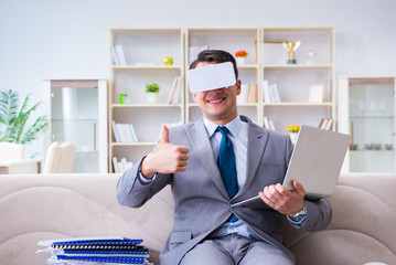 Businessman with virtual reality glasses in modern technology co