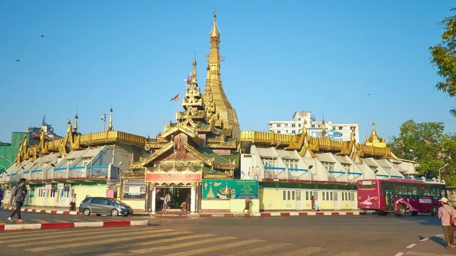 YANGON, MYANMAR - FEBRUARY 17, 2018: Morning activity in Downtown, numerous pedestrians on crossing on the roundabout at medieval Sule Pagoda, on February 17 in Yangon.