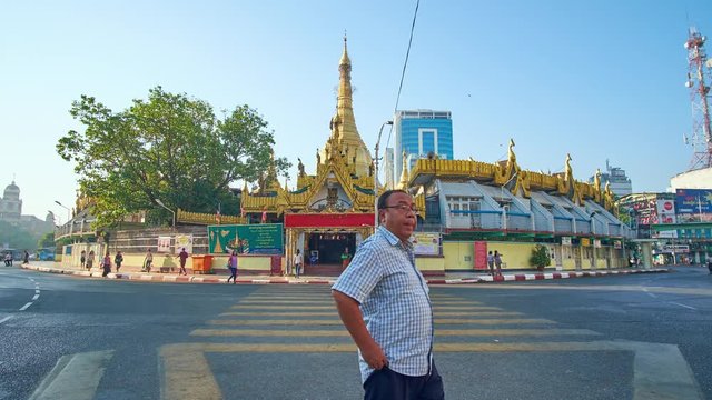 YANGON, MYANMAR - FEBRUARY 17, 2018: Historic Sule Pagoda located in busy crowded neighborhood and neighbors with Chinatown, it's one of most popular landmarks of Downtown, on February 17 in Yangon.