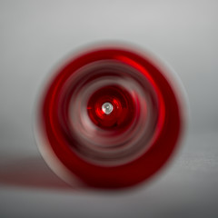 Red and gray blurred swirls in the center of a square gray background
