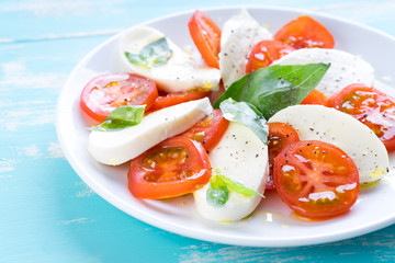 Italian style salad with mozzarella cheese tomato basil summer light olive oil