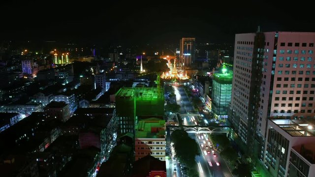 lights of cars at night near Sula Pagoda which is located in the heart of downtown Yangon, Myanmar