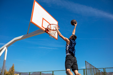 Young Basketball street player making slam dunk © FS-Stock
