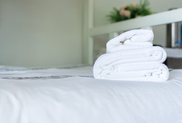 Fototapeta na wymiar White hotel towel on bed,Stack of fluffy bath towels