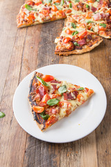 Rustic-looking Pizza Slice on unique wooden background