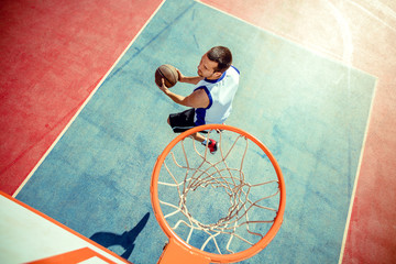 High angle view of basketball player dunking basketball in hoop
